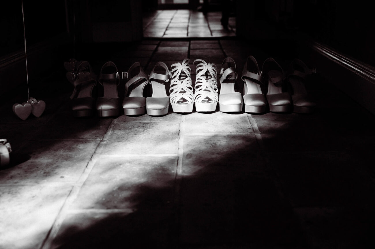 details of bride and bridemaids shoes in the light and shadows