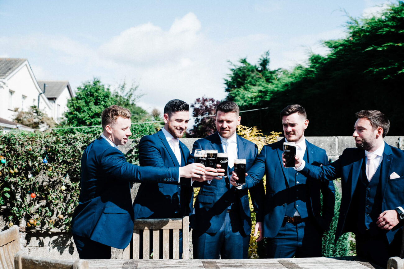 Groomsmen toasting a pint of Guinness