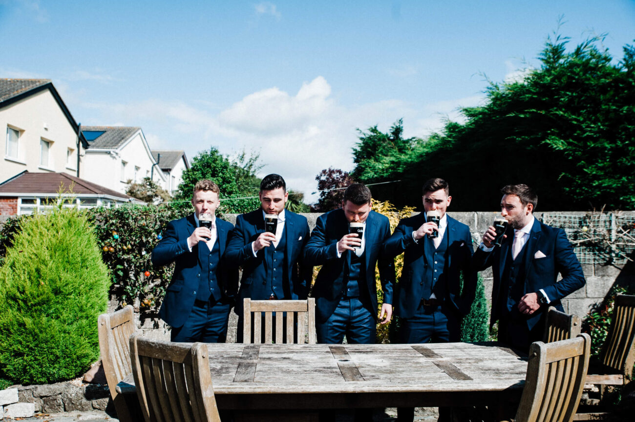 Groomsmen toasting a pint of Guinness