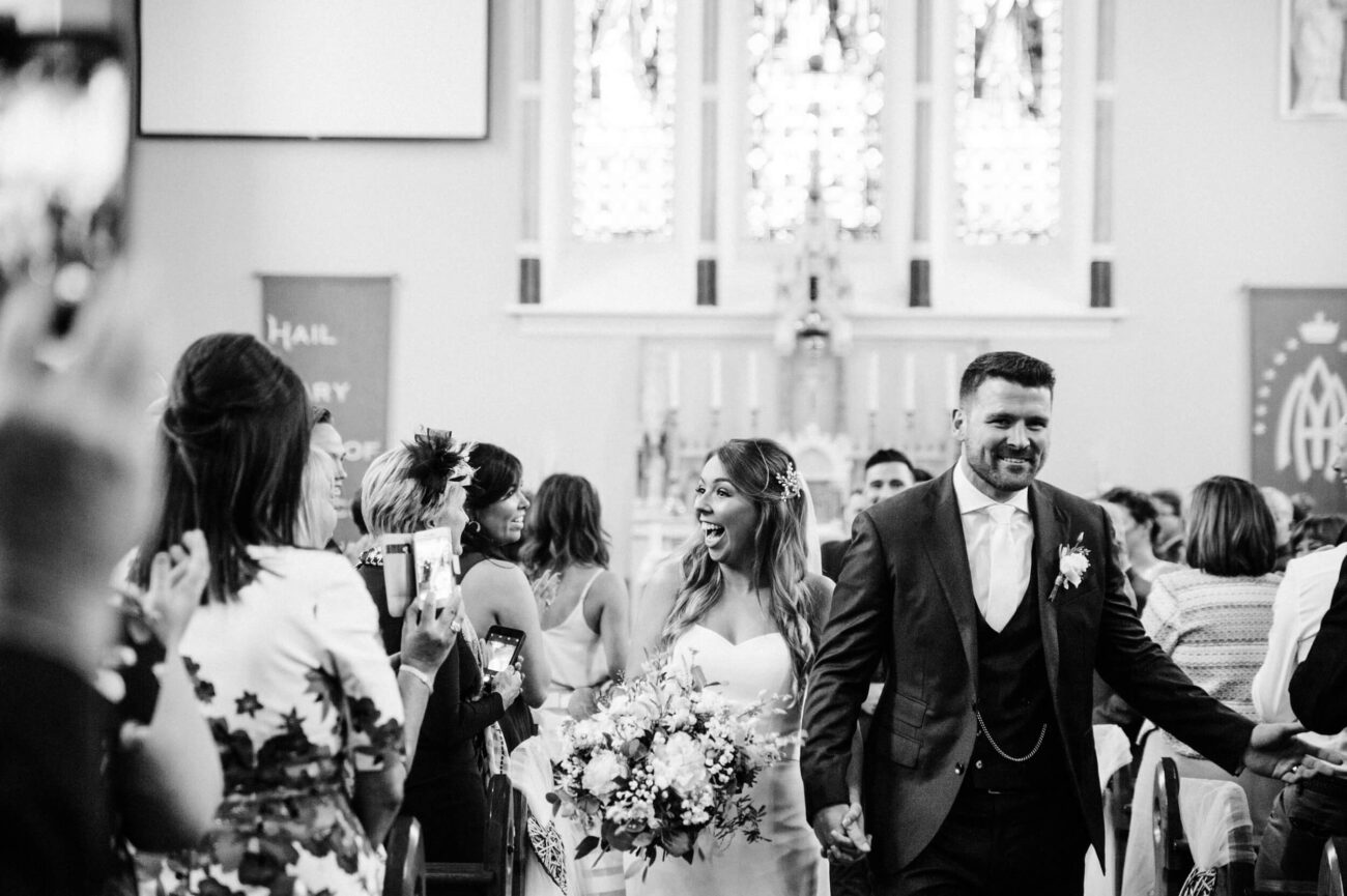 Couple walking down the aisle at St Sylvester's Church, Malahide