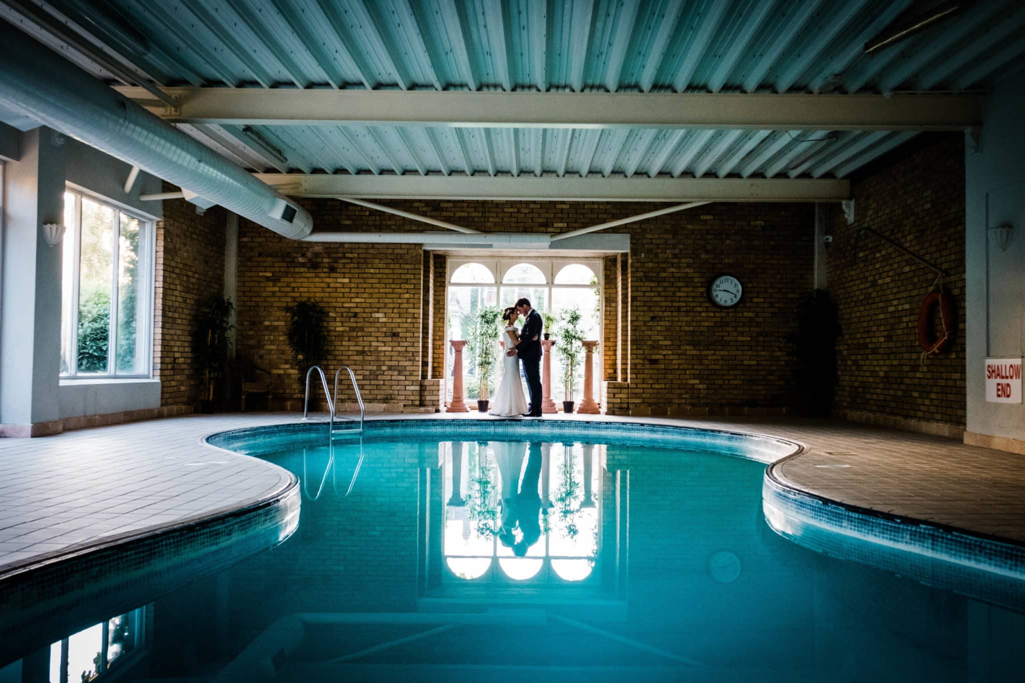 newlyweds standing by the pool at Finnstown House