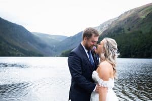 bride and groom kissing at Glendalough lake