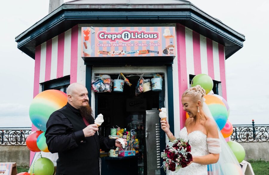 Bride and groom eating ice cream on the beach front in Bray, Bride and groom portrait on Bray Breach front, wedding portrait in Bray, wedding photographer Bray, wedding Photographer Dublin