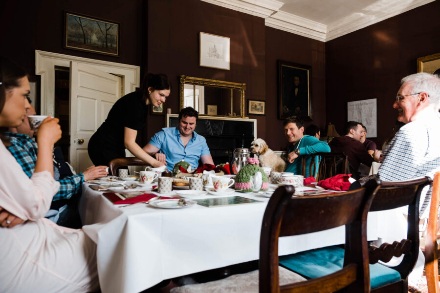 Groom and guests eating breakfast in Roundwood House, Country House wedding venue