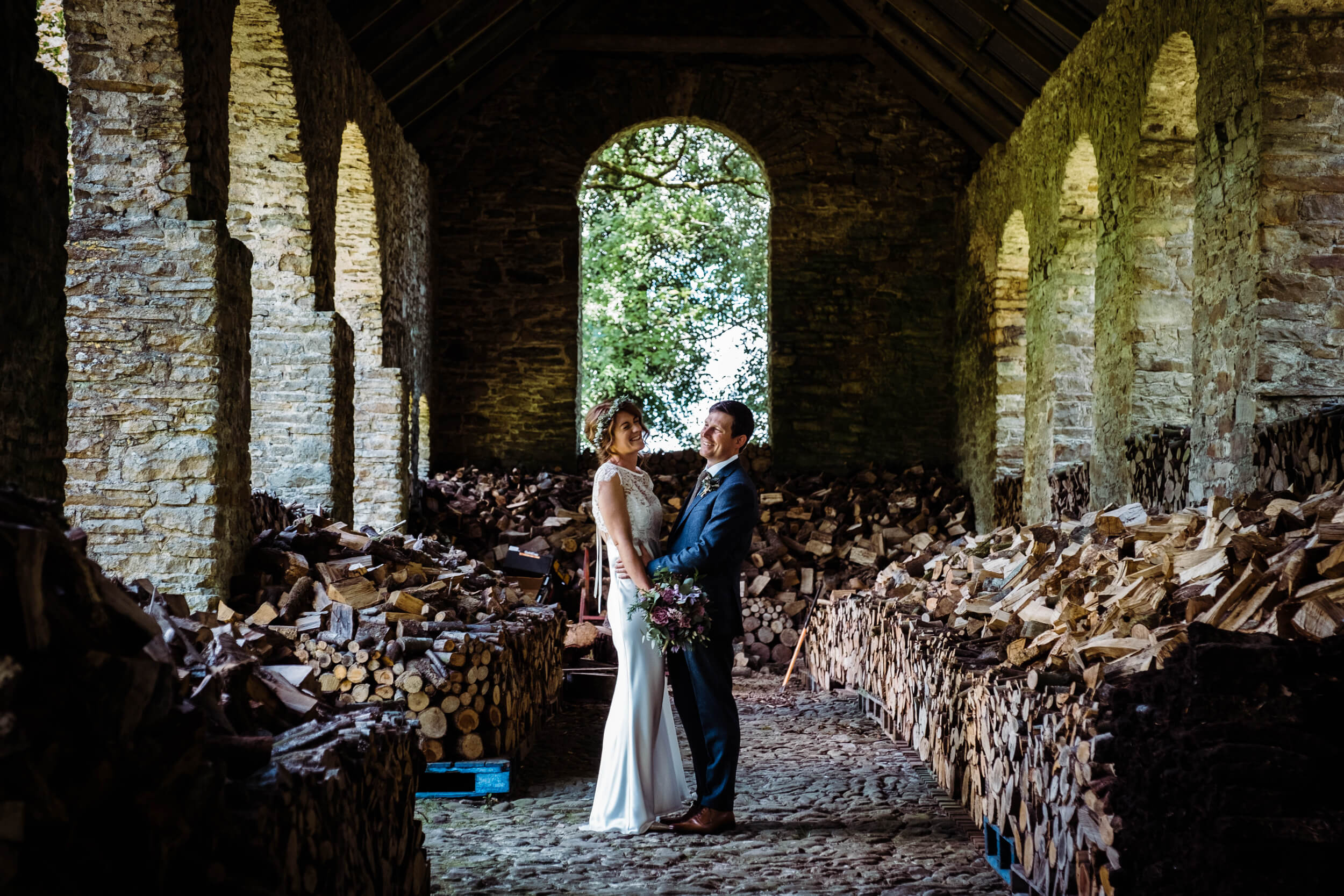 Country House wedding venue Ireland, couple standing in a barn and laughing