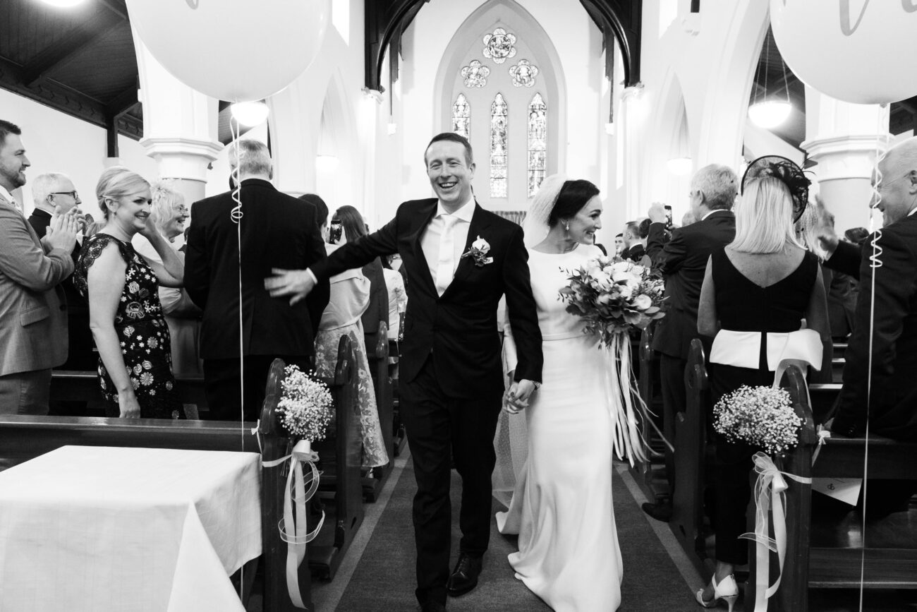 bride and Groom walking down the aisle at Keadue Church