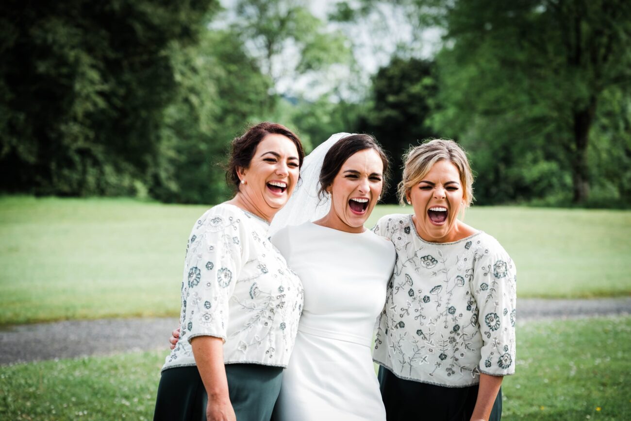Bridemaids and brdie laughing in the gardens of Kilronan Castle