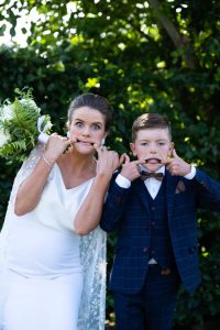 bride and page boy making funny faces in family portraits at Castleknock Hotel