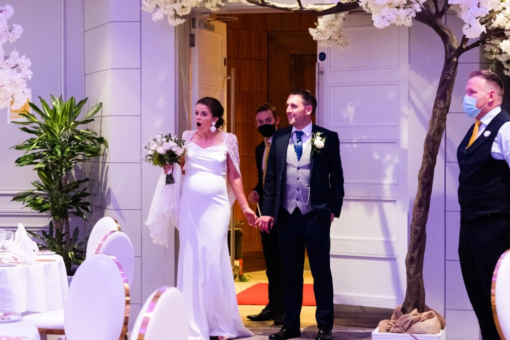 Bride and groom walking into the reception room at The Castleknock Hotel