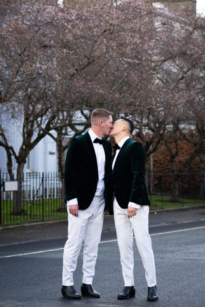 Groomsmen kissing and holding hands