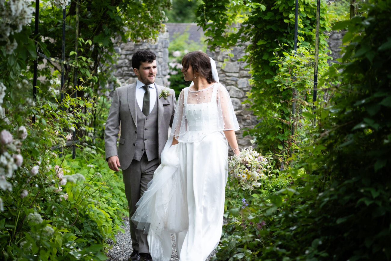 Wedding at Ballintubbert House and Gardens wedding, couple walking down the pathway facing each other