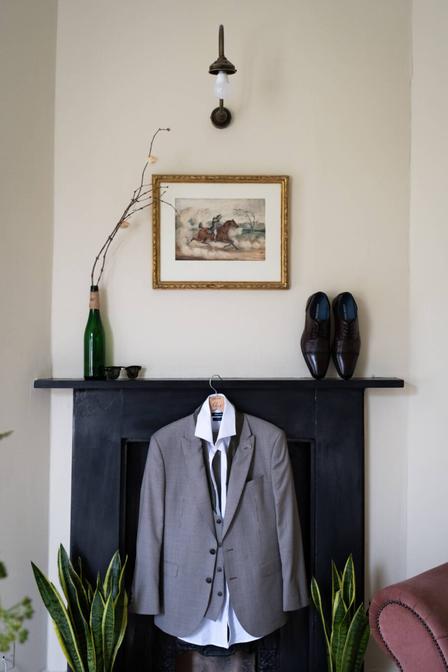 Grooms suit during bridal prep hanging on the fireplace