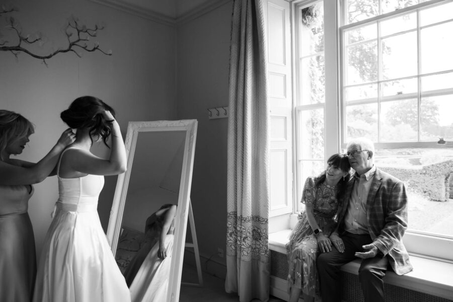 Parents looking proudly at bride in bridal prep room at Ballintubbert House and Gardens