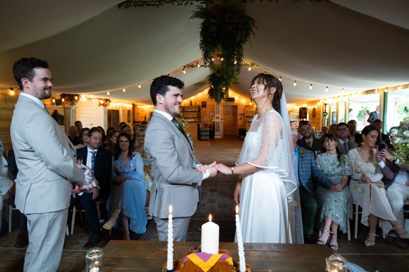 couple laughing out loud during ceremony in Ballintubbert Gardens and House, candid wedding photos