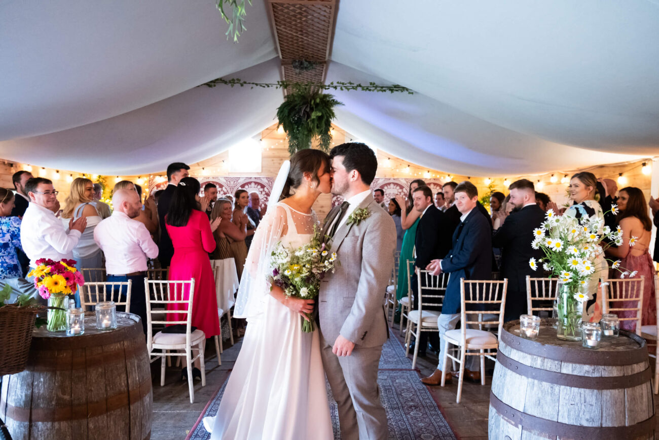 Bride and groom kissing at the aisle at Ballintubbert Gardens and House