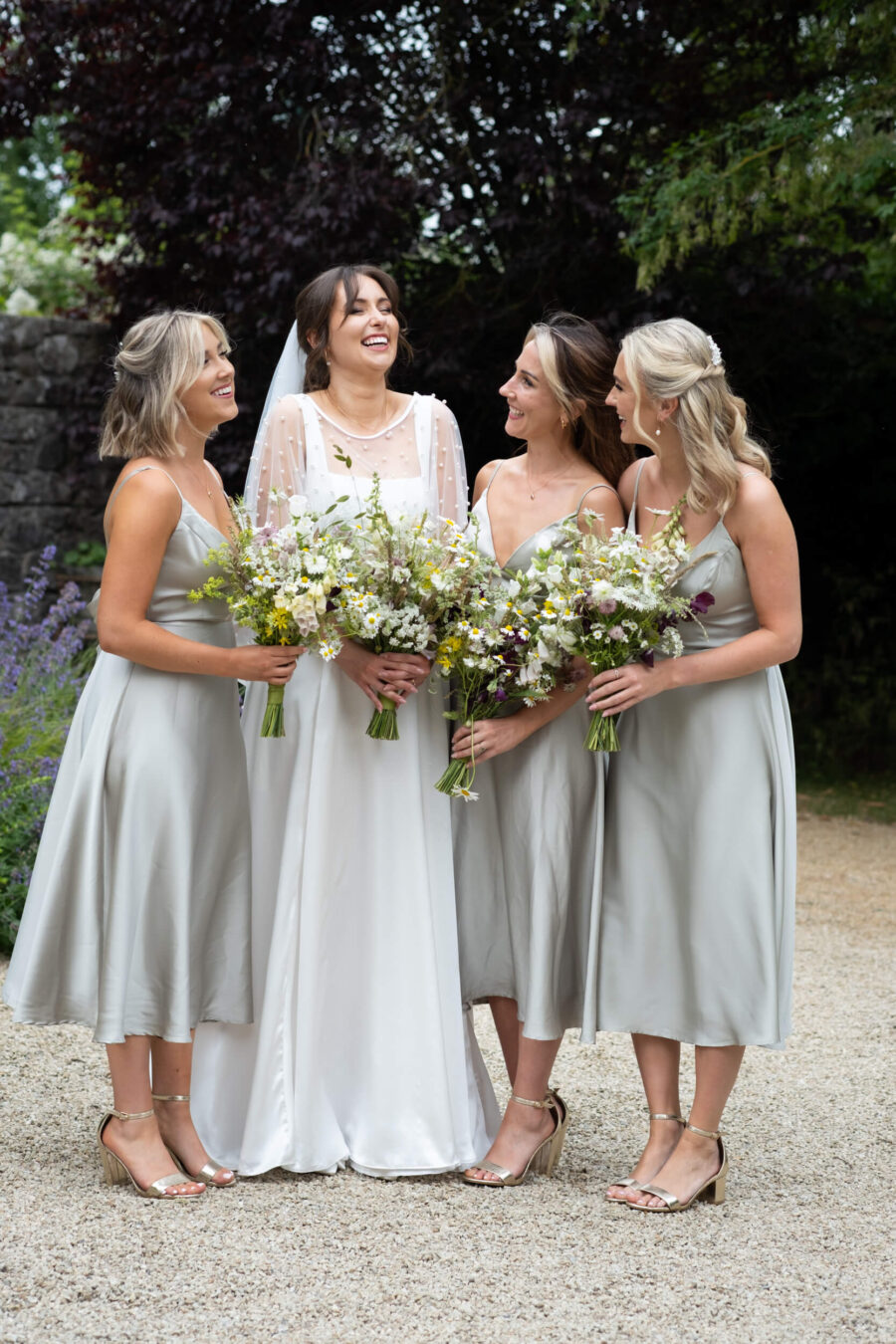 Bride and bridesmaids laughing at the front of the house in Ballintubbert Gardens and House