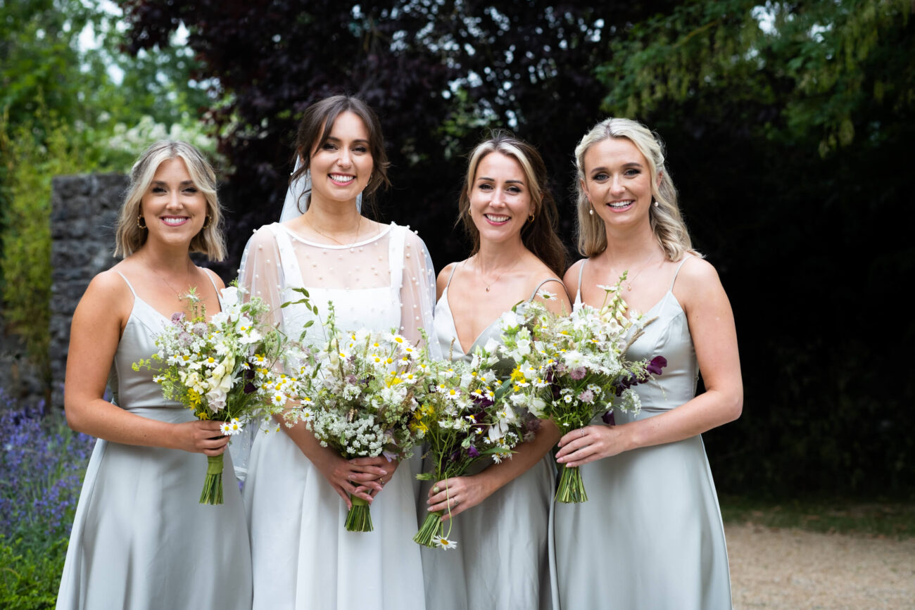 Bride and bridesmaids posing at the front of the house in Ballintubbert Gardens and House