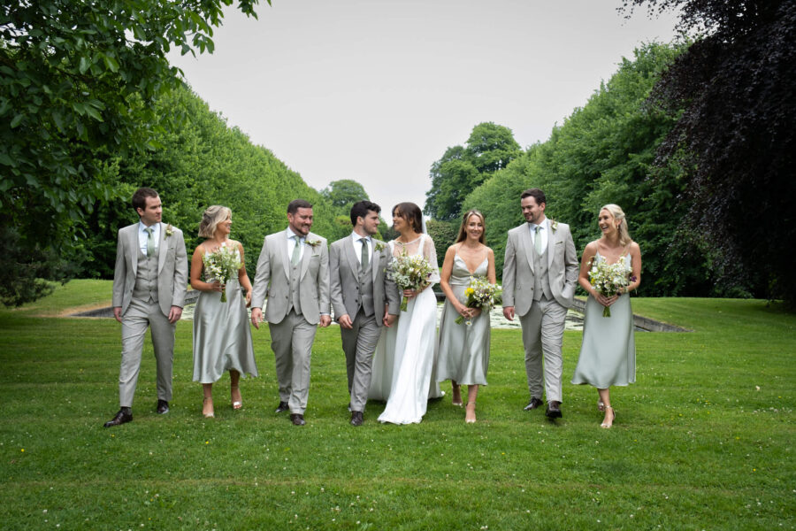 Bridal party walking together at the front of the house in Ballintubbert Gardens and House