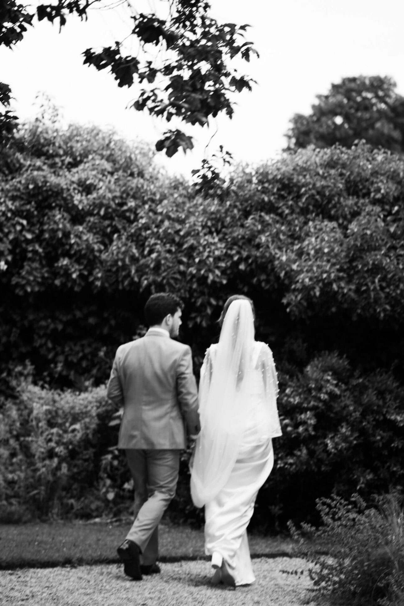 bride and groom walking into the flower garden of Ballintubbert Gardens and House