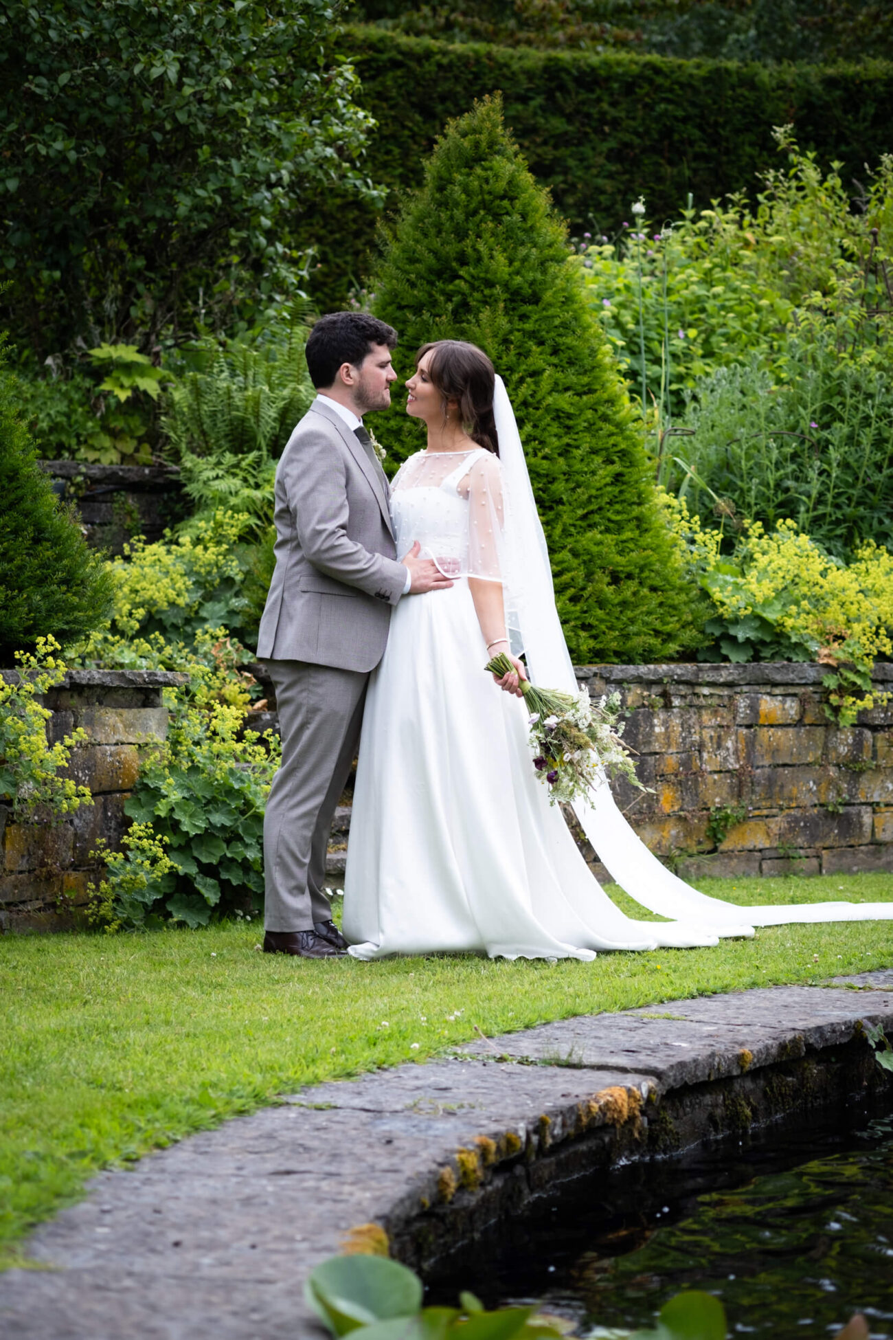 Bride and groom facing each other lovingly The Fountain Garden of Ballintubbert Gardens and House