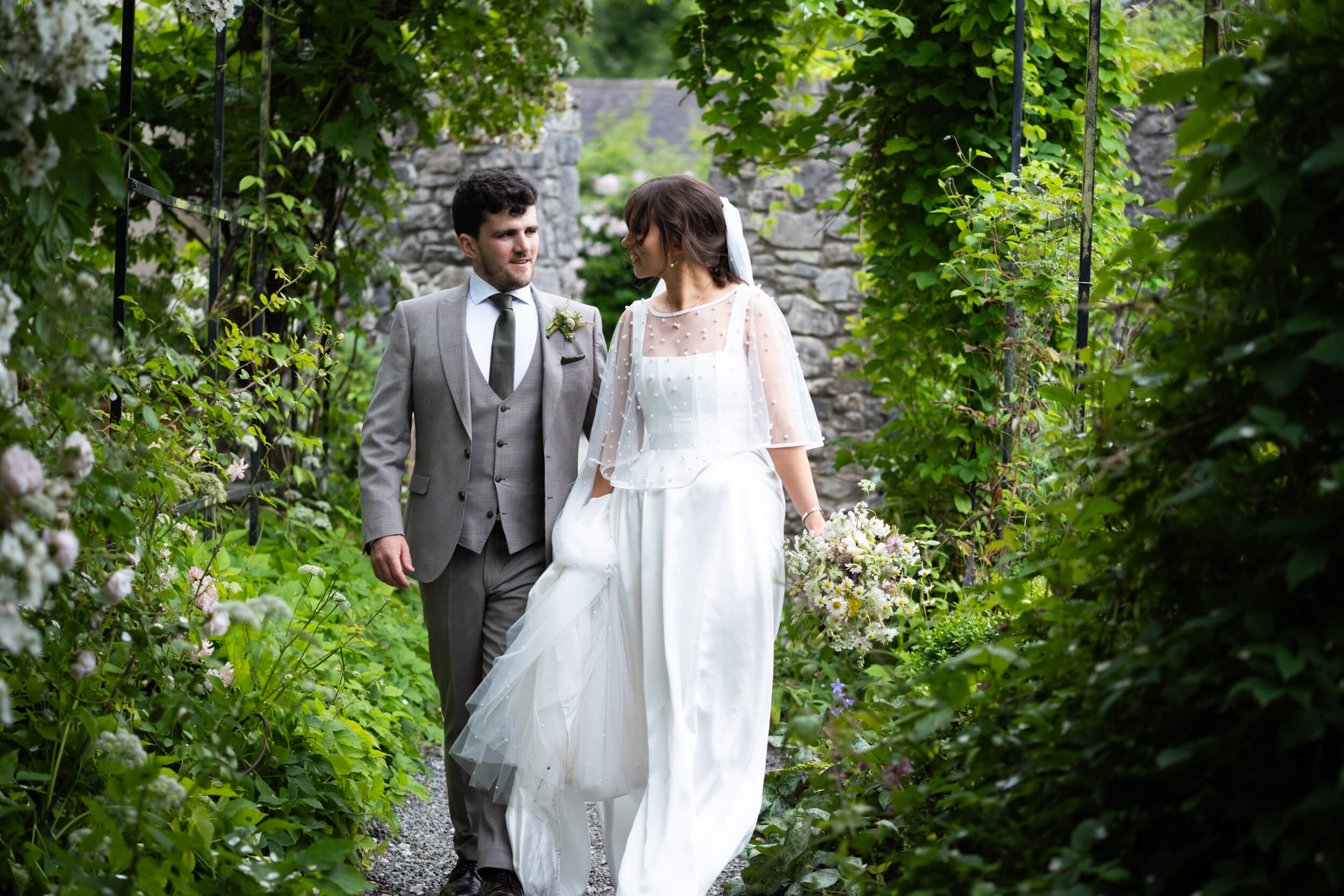 Bride and Groom walking down the path to The Tabernacle of Ballintubbert Gardens and House