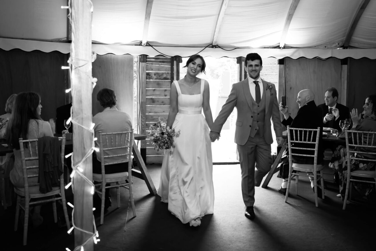 Bride and groom making their grand entrance into the marquee at Ballintubert House and Gardens