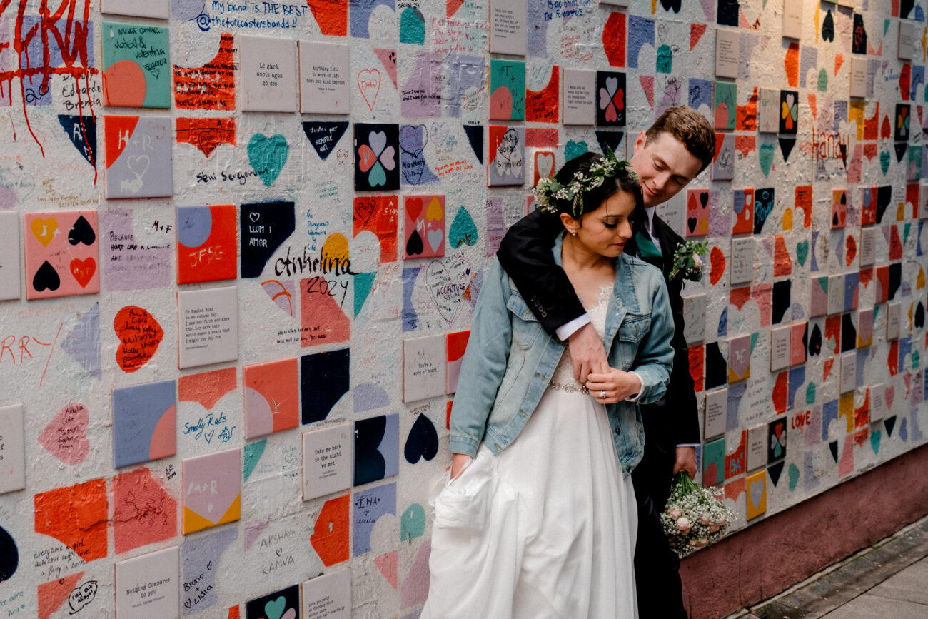 couple standing at the Lovers Lane wall in Temple Bar