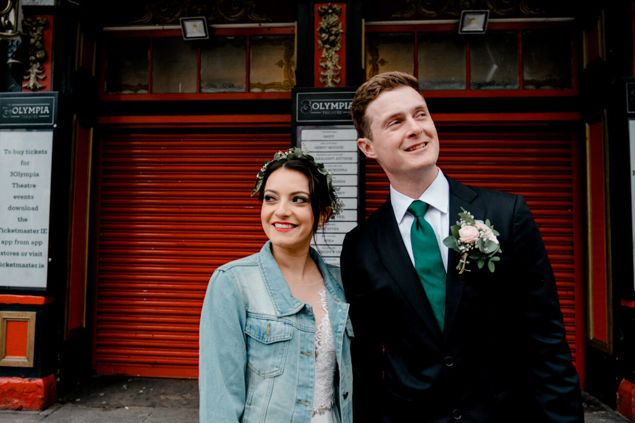 Couple standing in front of The Olympia Theatre in Dublin. Dublin elopement