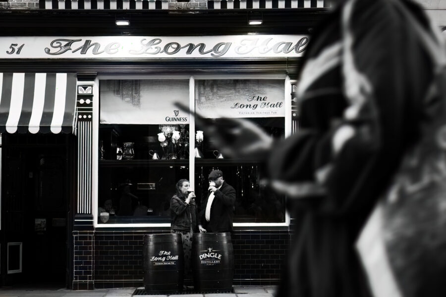 Engagement photoshoot in Dublin City Centre at The Long Hall Pub, Couple drinking a Guinness outside the Long Hall