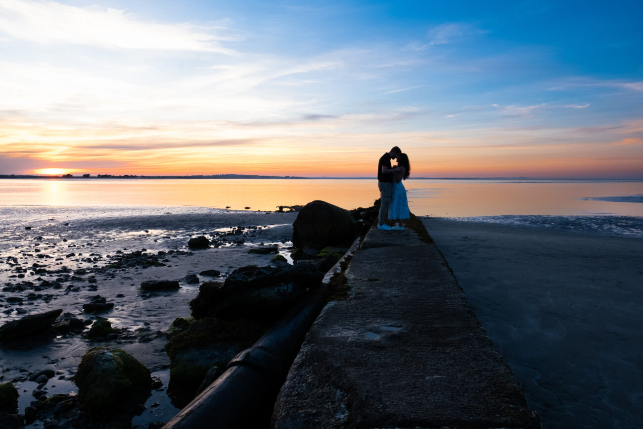 wide shot of couple in the sunset at Burrow Beach, Howth