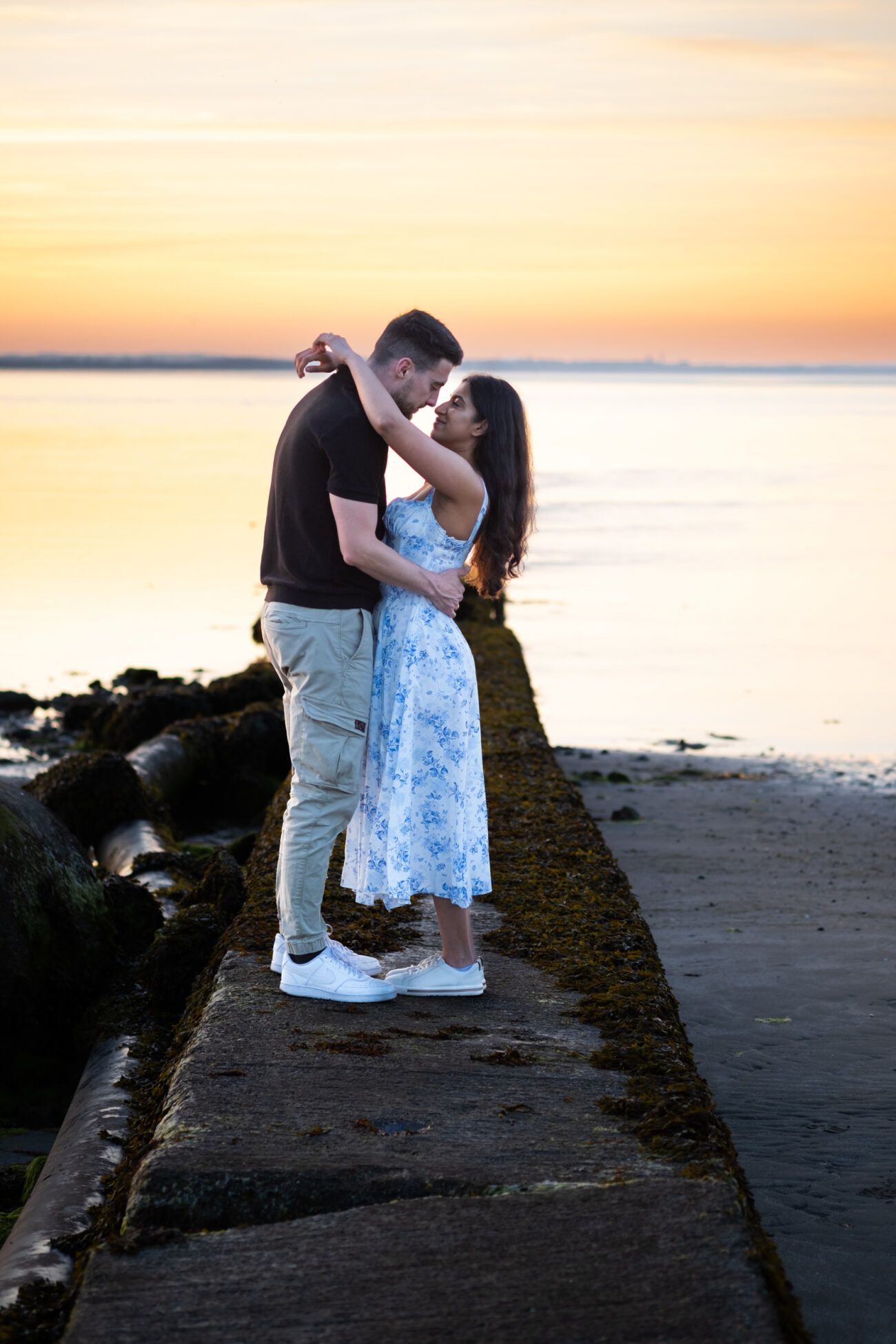 couple standing on the jetty at Burrow Beach in Howth