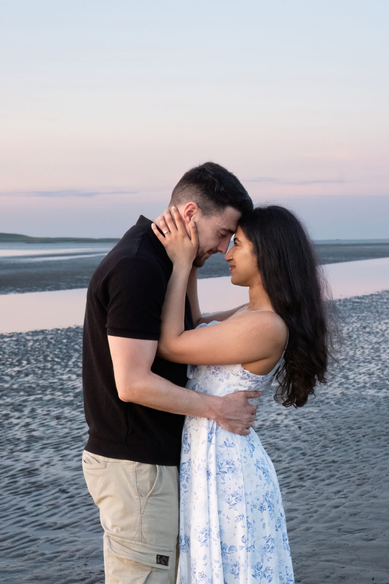 couple facing each other and looking into each others eyes in Burrow Beach, Howth