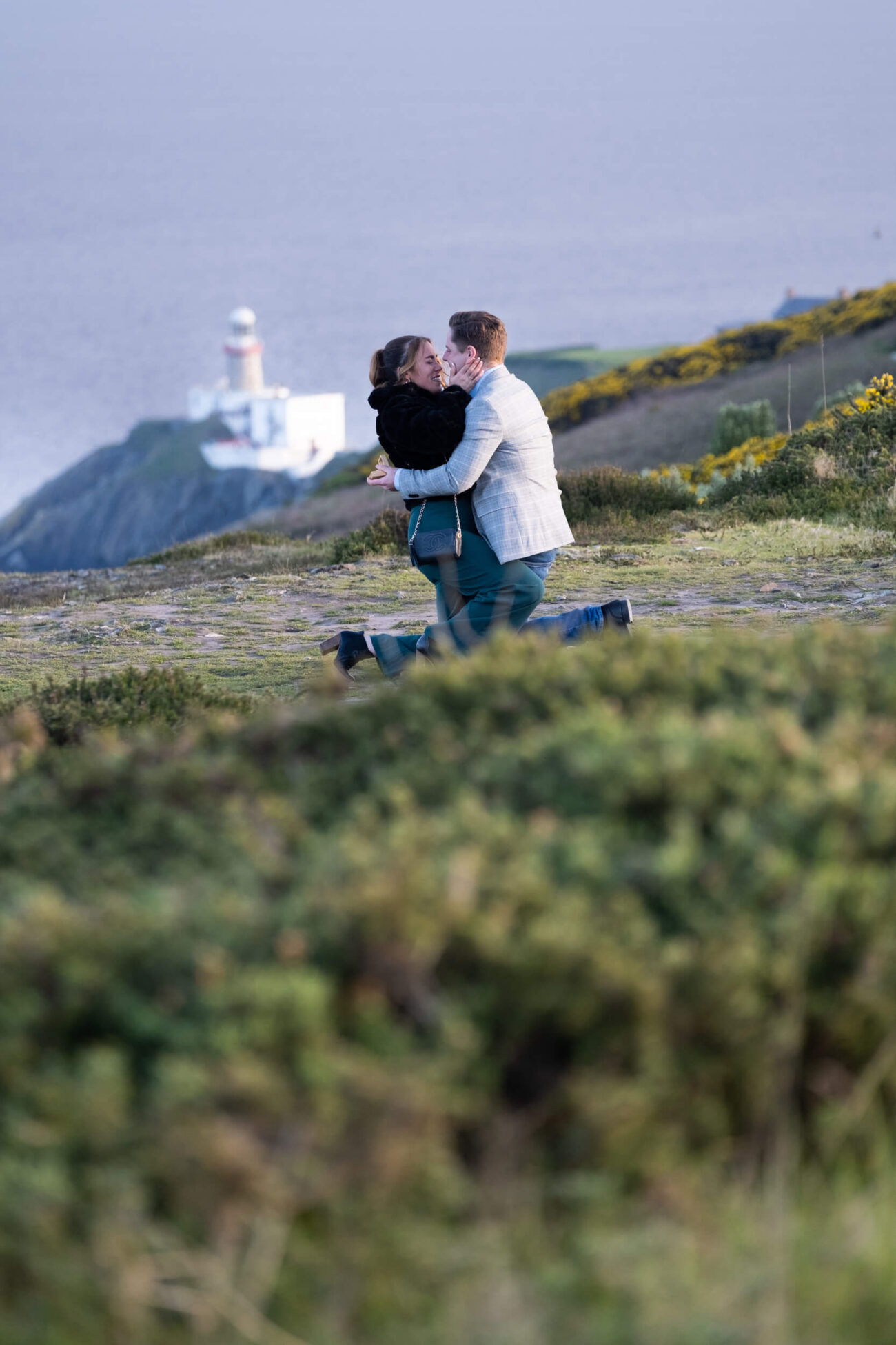 Howth Head engagement shoot, a secret proposal at Howth Head, couple embrace after a secret proposal