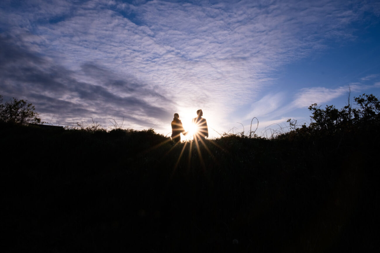 Howth Head engagment photos. Couple silhouetted on a hill at Howth Head