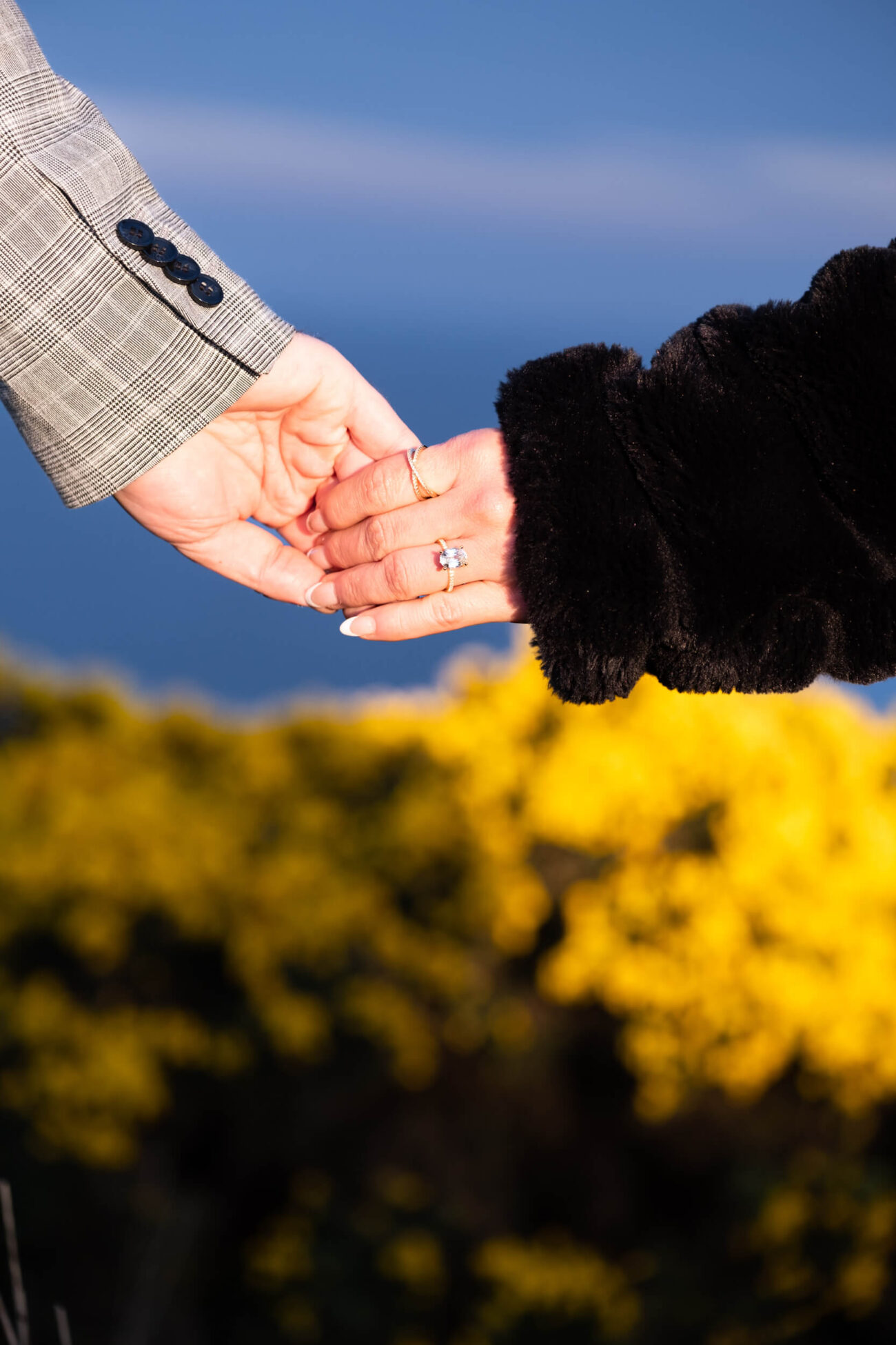 Howth Head engagement shoot, a secret proposal at Howth Head, hands holding with engagement ring