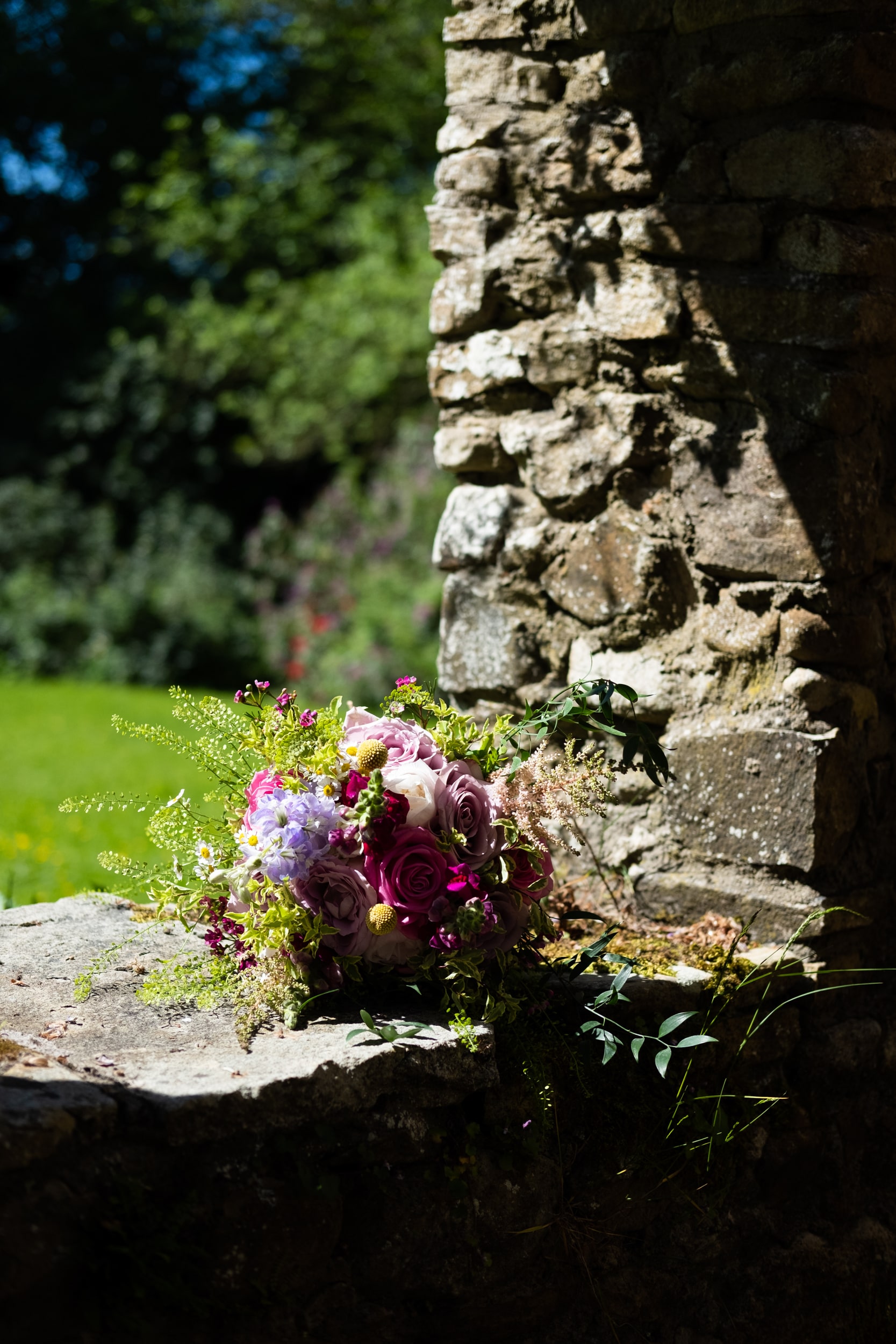 Brides flowers on a stone wall at Roundwood House