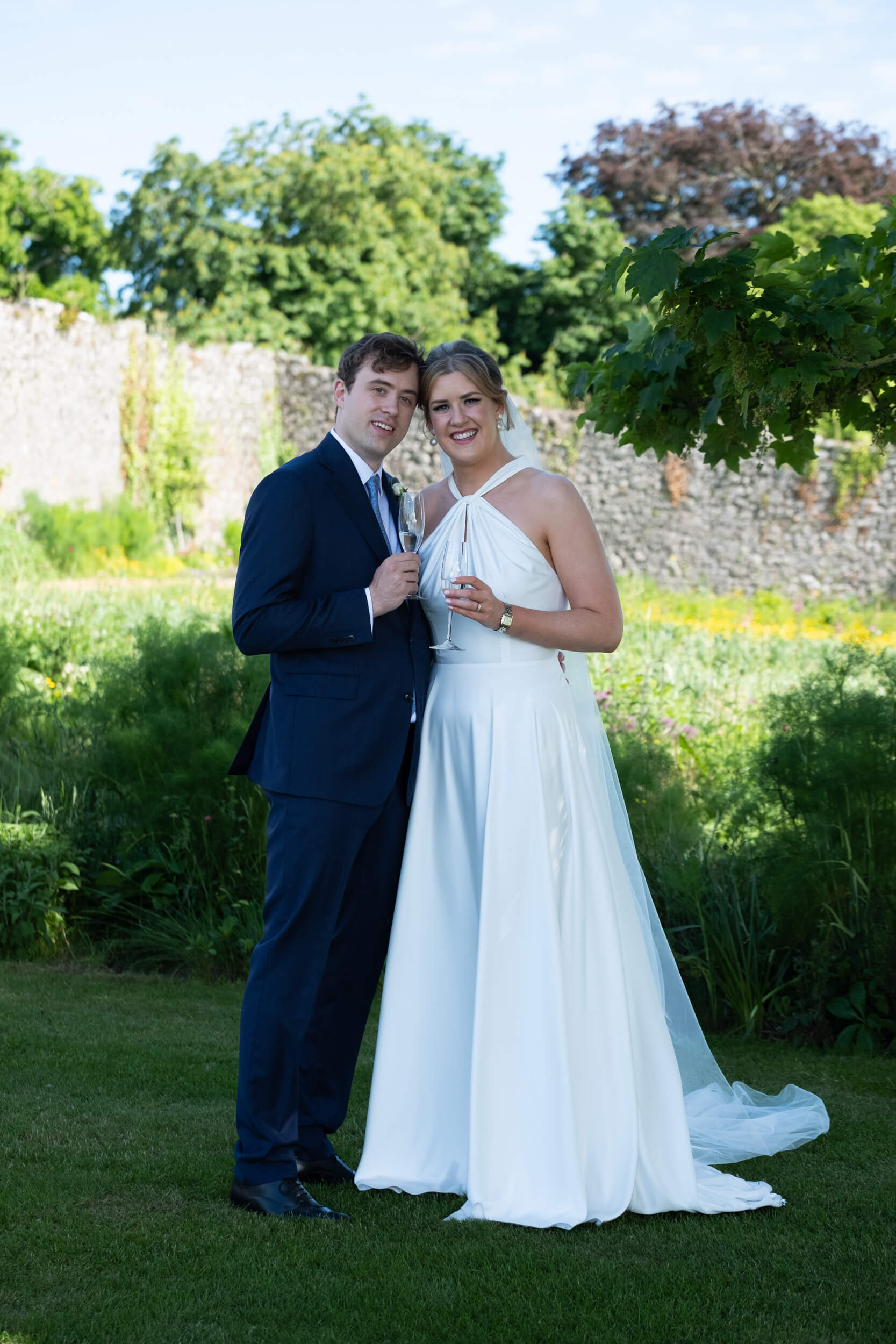 Bride and groom facing the camera in the gardens of Cloughjordan House