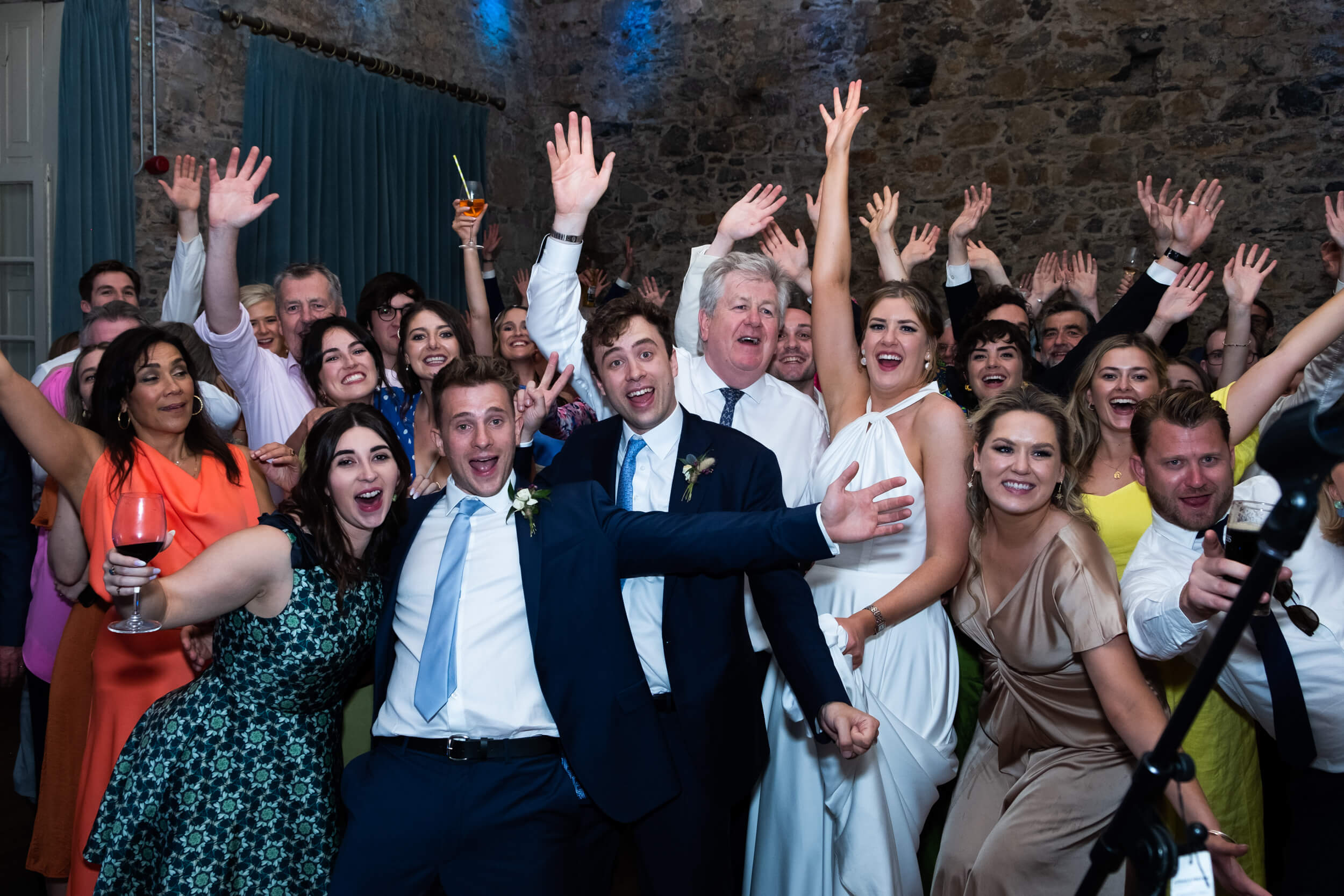 Wedding party guests all posing for group shot on the dance floor at Cloughjordan House
