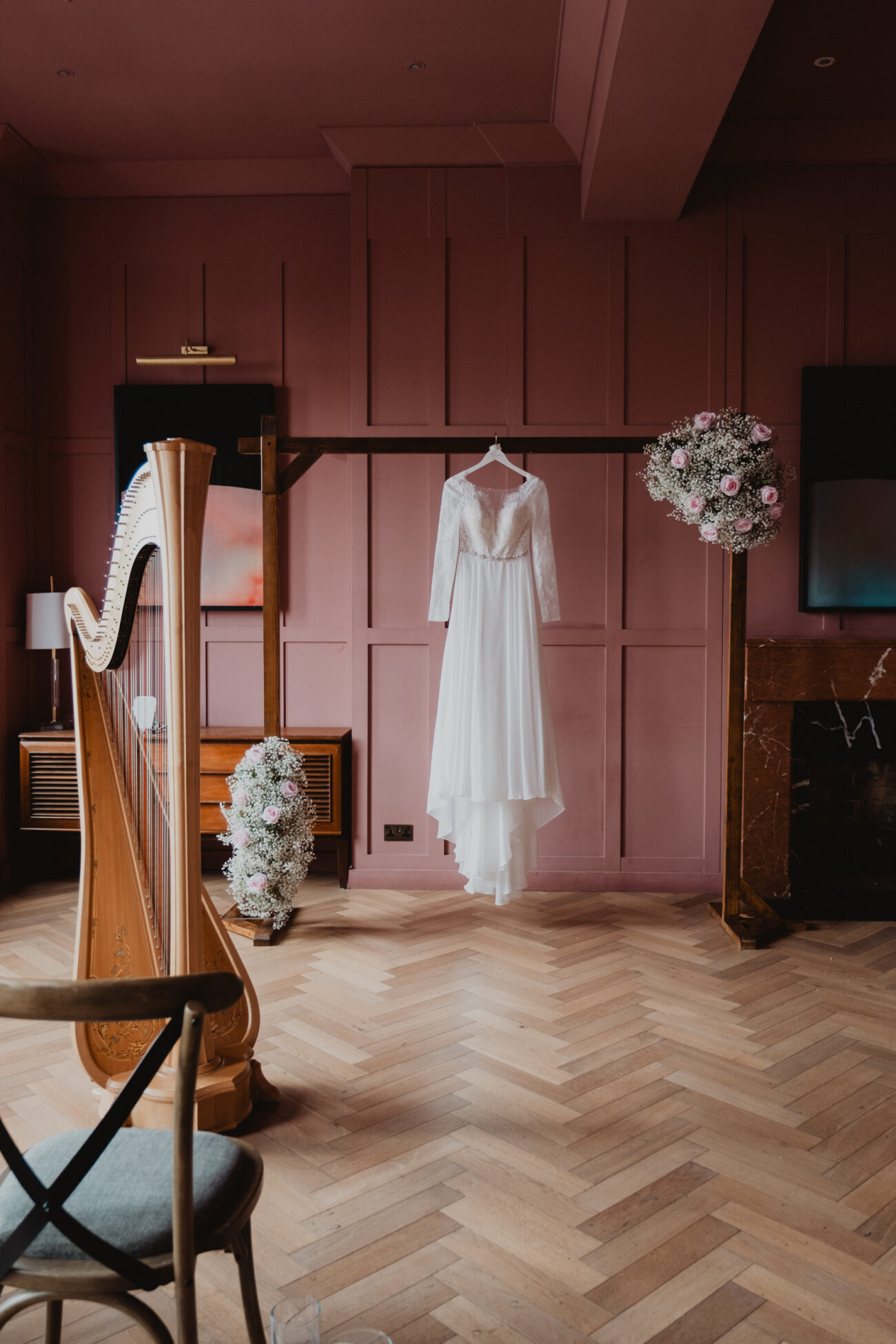 Wedding photography at The Clarence Hotel, Dublin city wedding, wedding dress hanging in the Rose Room