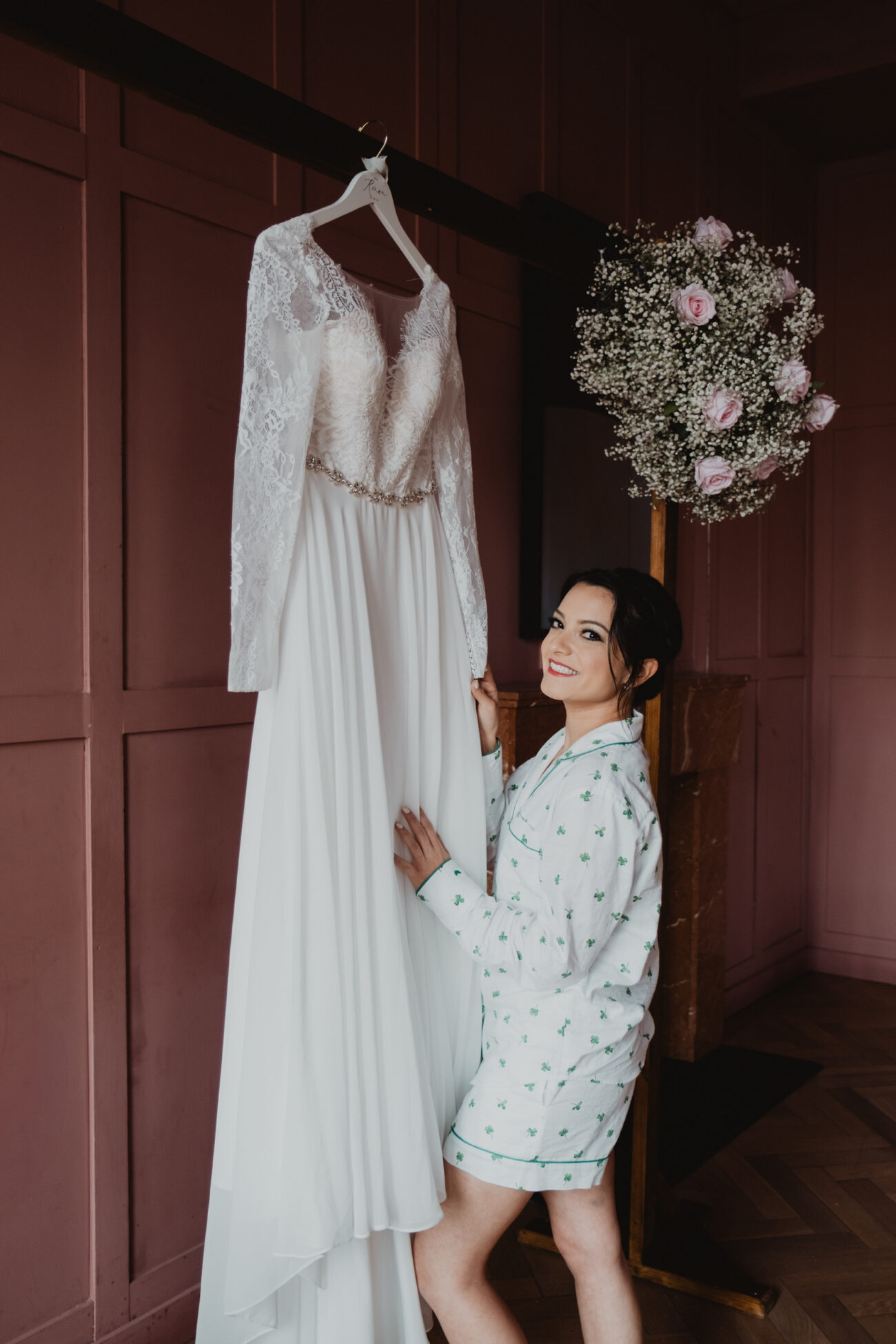 bride looking her dress in the Rose Room at The Clarence Hotel, Elopement in Dublin City, Wedding at The Clarence Hotel