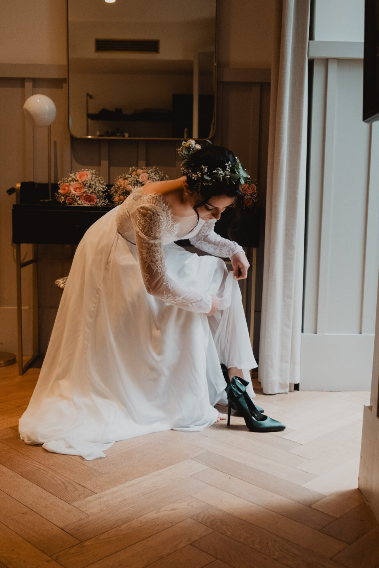 Bride putting her shoes on during bridal prep at The Clarence Hotel