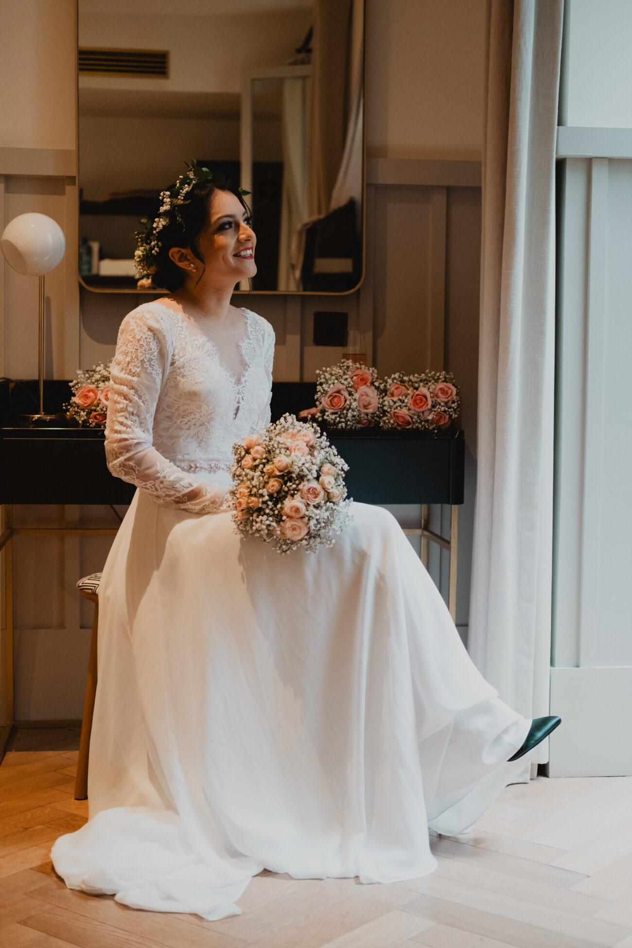 Bride sitting and looking out the window in her dress during bridal prep, Wedding at The Clarence Hotel