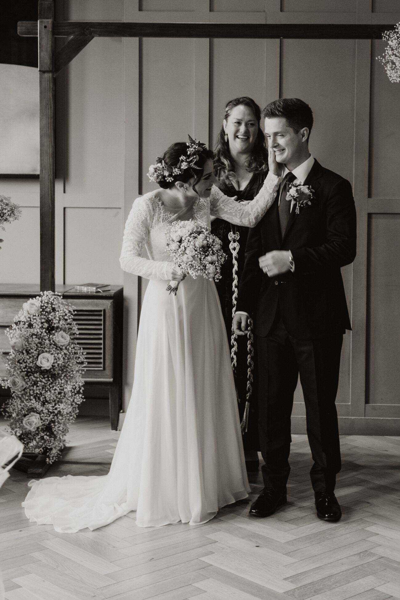 bride wiping lipstick off grooms face after first kiss at The Clarence Hotel