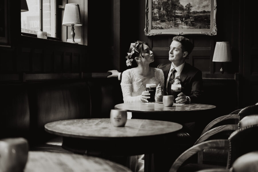 bride and groom drinking some guinness at The Oak Bar at The Clarence, wedding at The Clarence Hotel