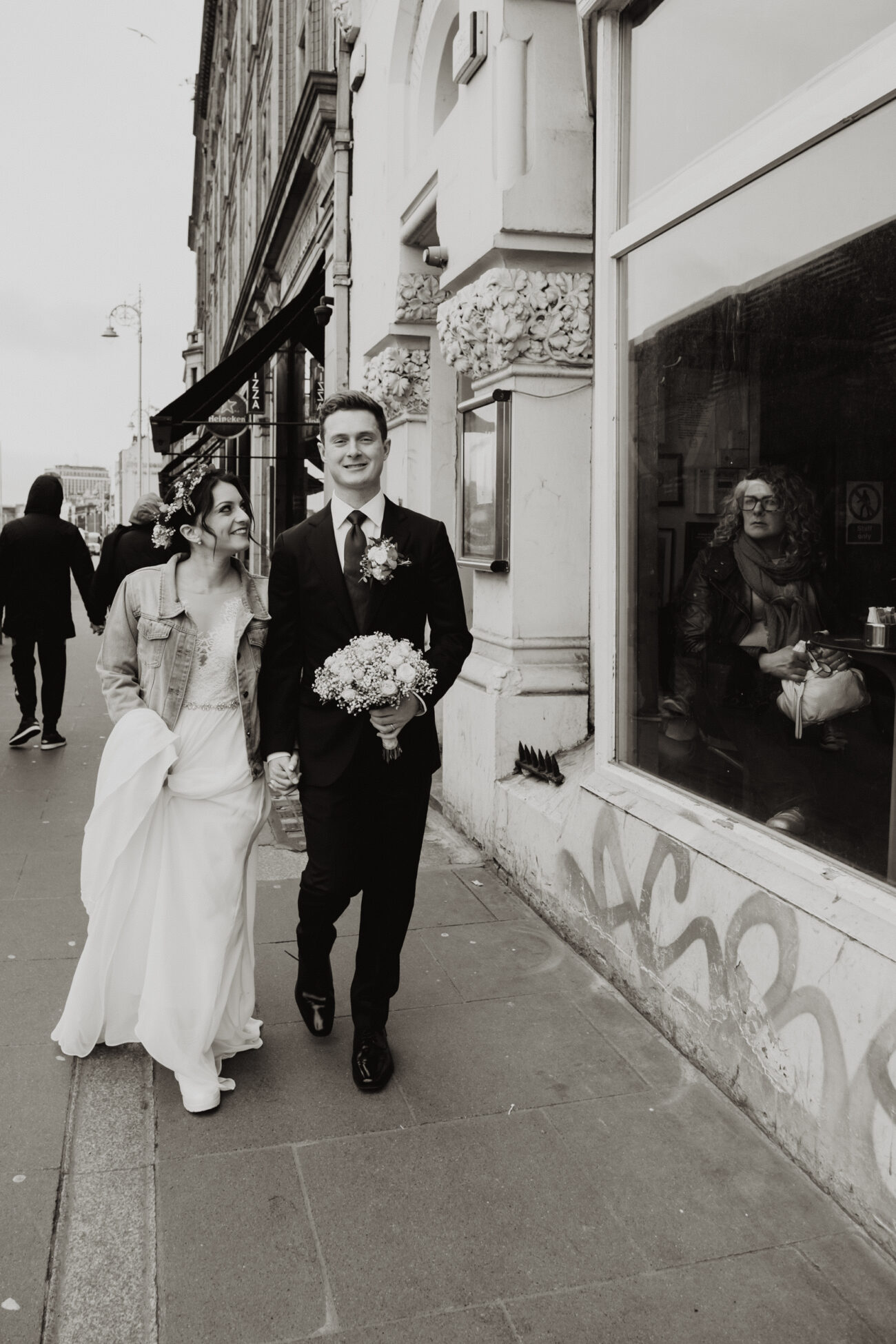 Bride and groom walking down the streets of Dublin, wedding at The Clarence Hotel, Dublin City wedding, Elopement in Dublin city