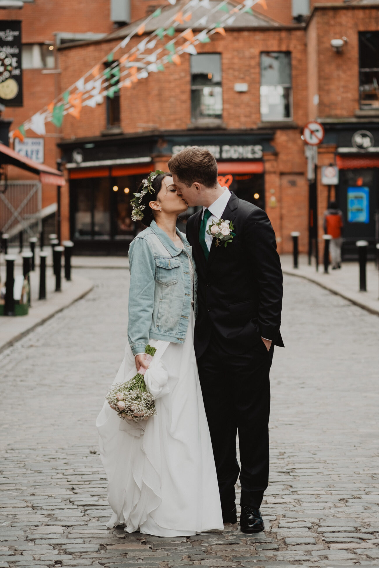 Bride and groom walking down the streets of Temple Bar, wedding at The Clarence Hotel, Dublin City wedding, Elopement in Dublin city