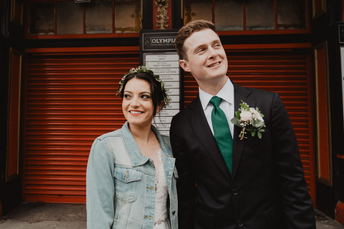 Bride and groom at the front of Olympia Theatre, wedding at The Clarence Hotel, Dublin City wedding, Elopement in Dublin city