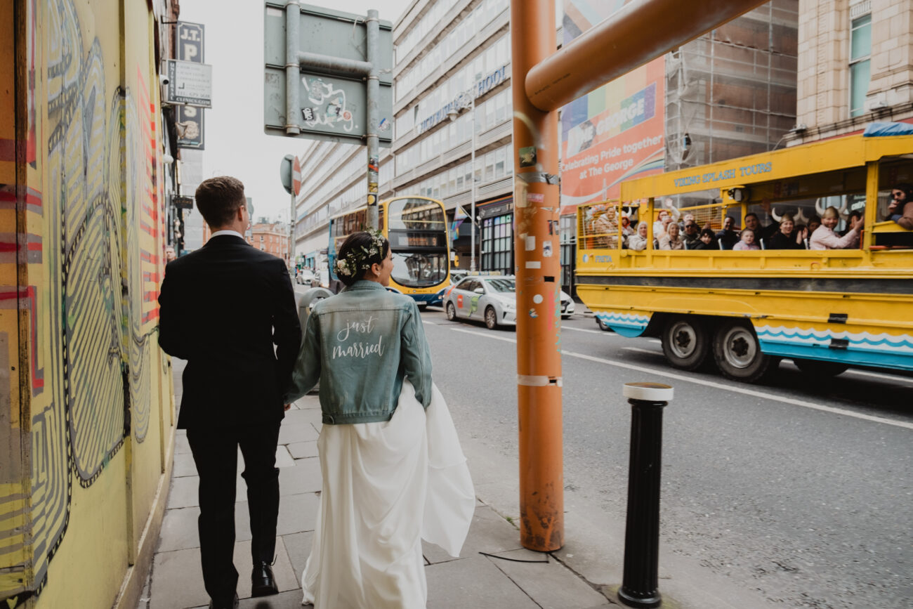 Bride and groom walking down Georges Street, wedding at The Clarence Hotel, Dublin City wedding, Elopement in Dublin city