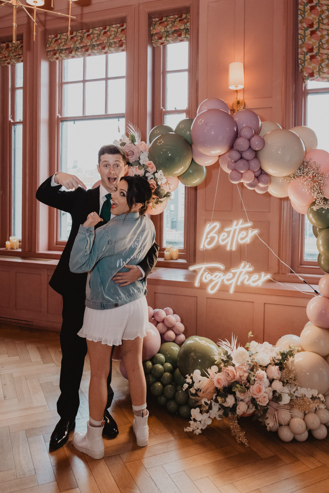 Couple standing in front of balloon sign at The Clarence Hotel