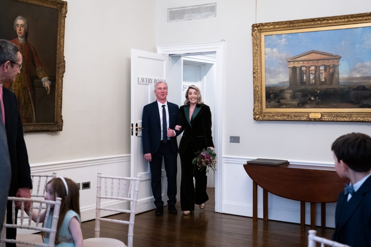 Bride walking into the ceremony room of no 5 South Leinster Street at her wedding at The National Gallery of Ireland